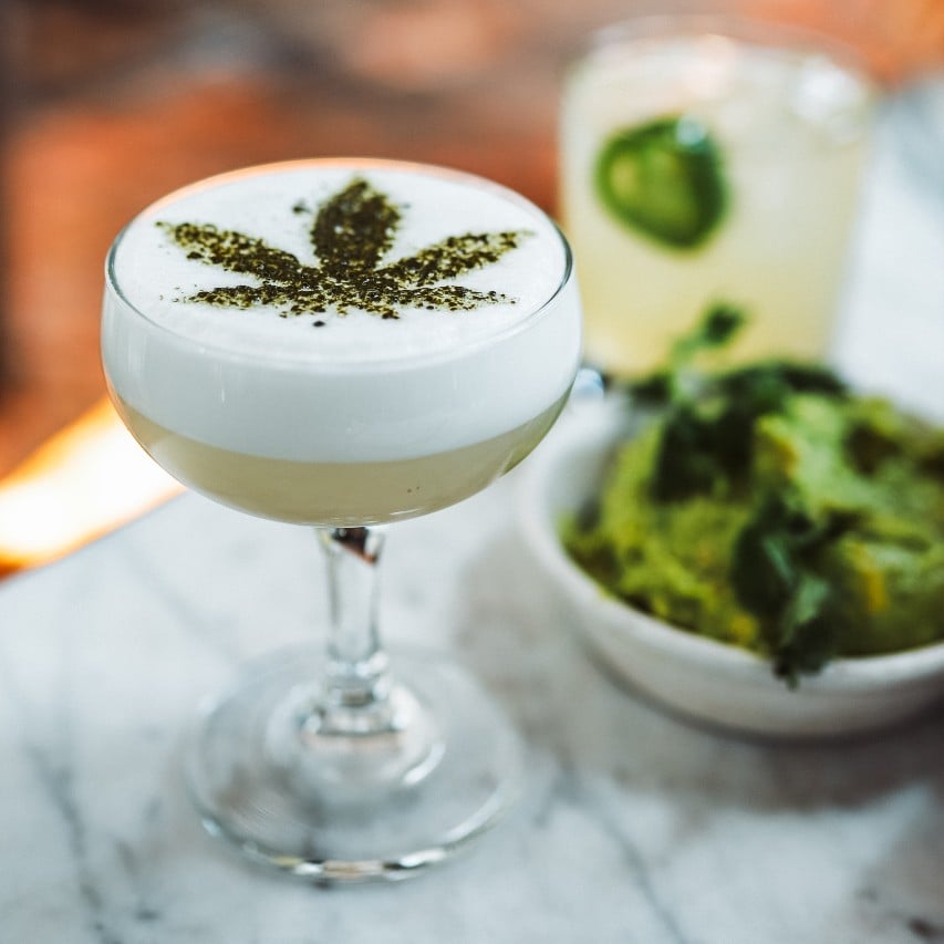 alcohol drink with glass with marijuana leave froth